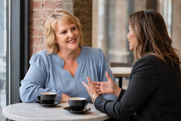 Two Women Talking at a Coffee Shop